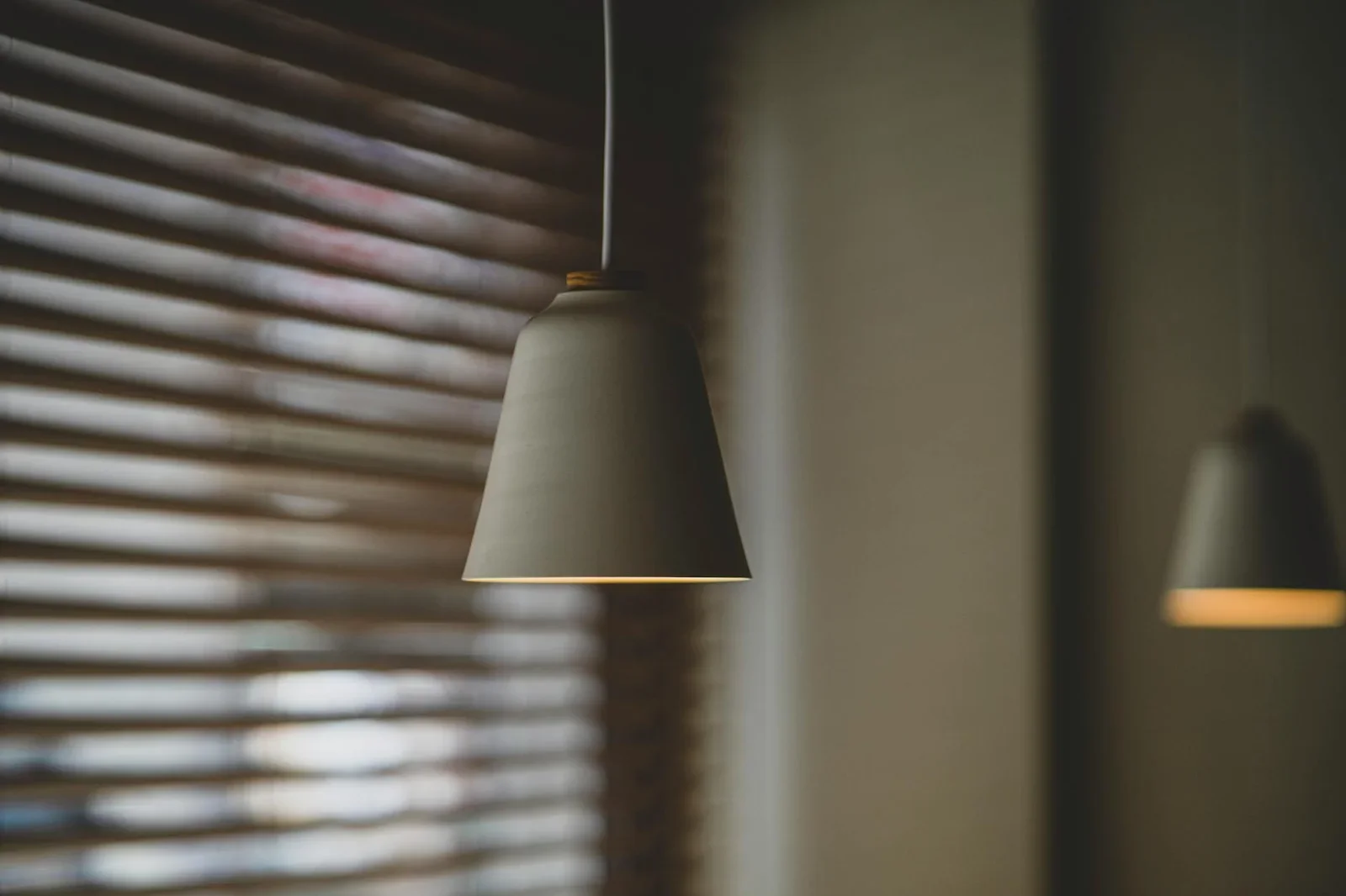 A minimalist pendant light against a soft focus background w | Thiết kế nội thất 24