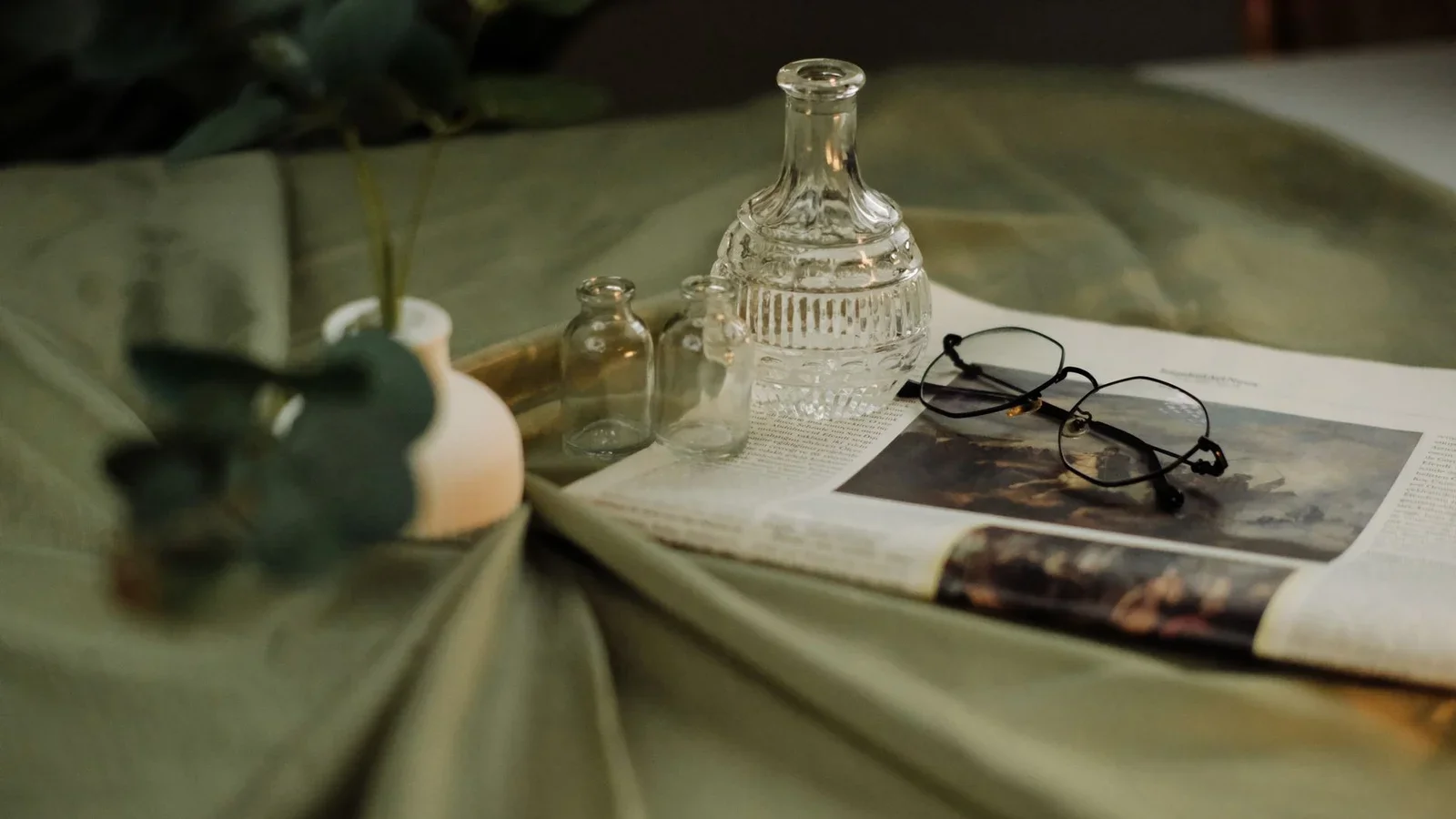A serene still life featuring glass bottles, eyeglasses, and | Thiết kế nội thất 24