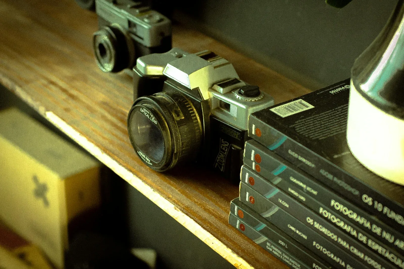 A retro camera on a wooden shelf with photographic books, ev | Thiết kế nội thất 24