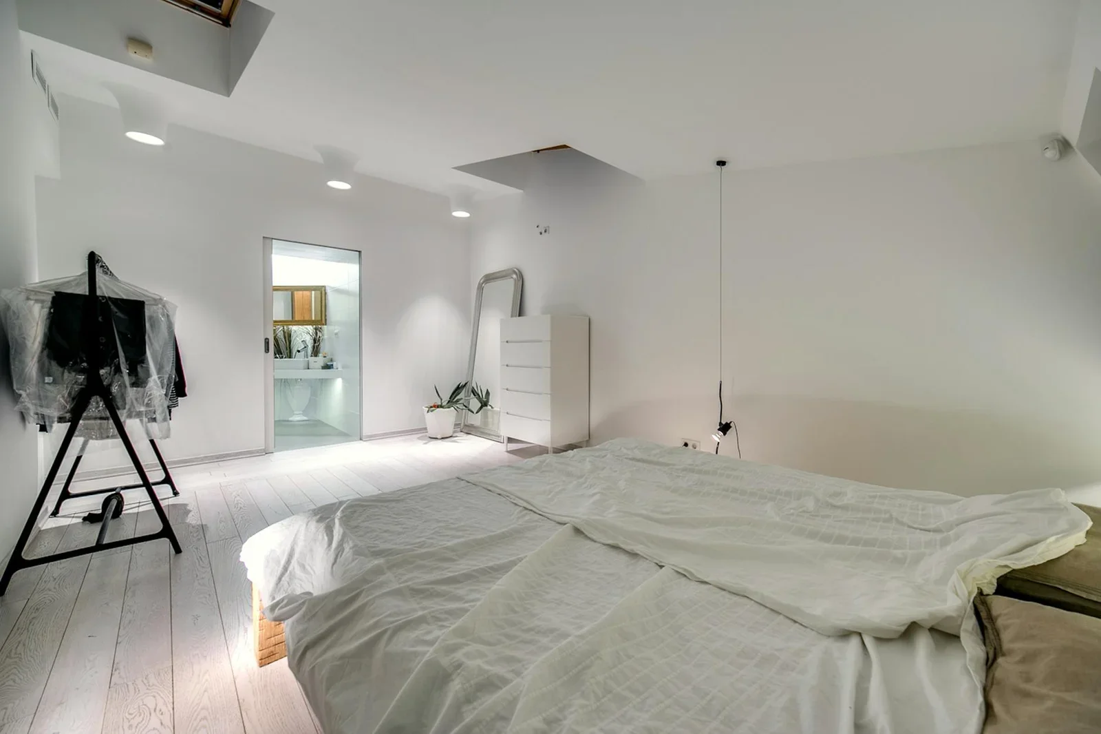 A modern minimalist bedroom featuring white decor, a cozy be | Thiết kế nội thất 24