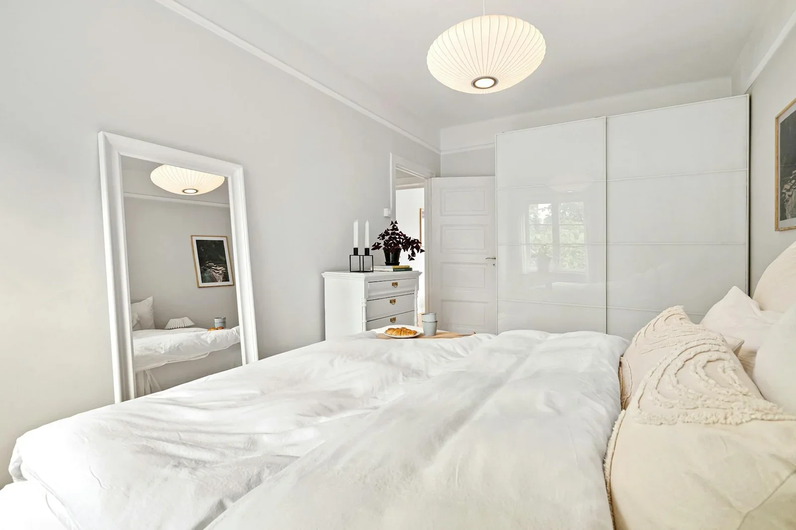 A minimalist bedroom with white decor, featuring a bed, dres | Thiết kế nội thất 24