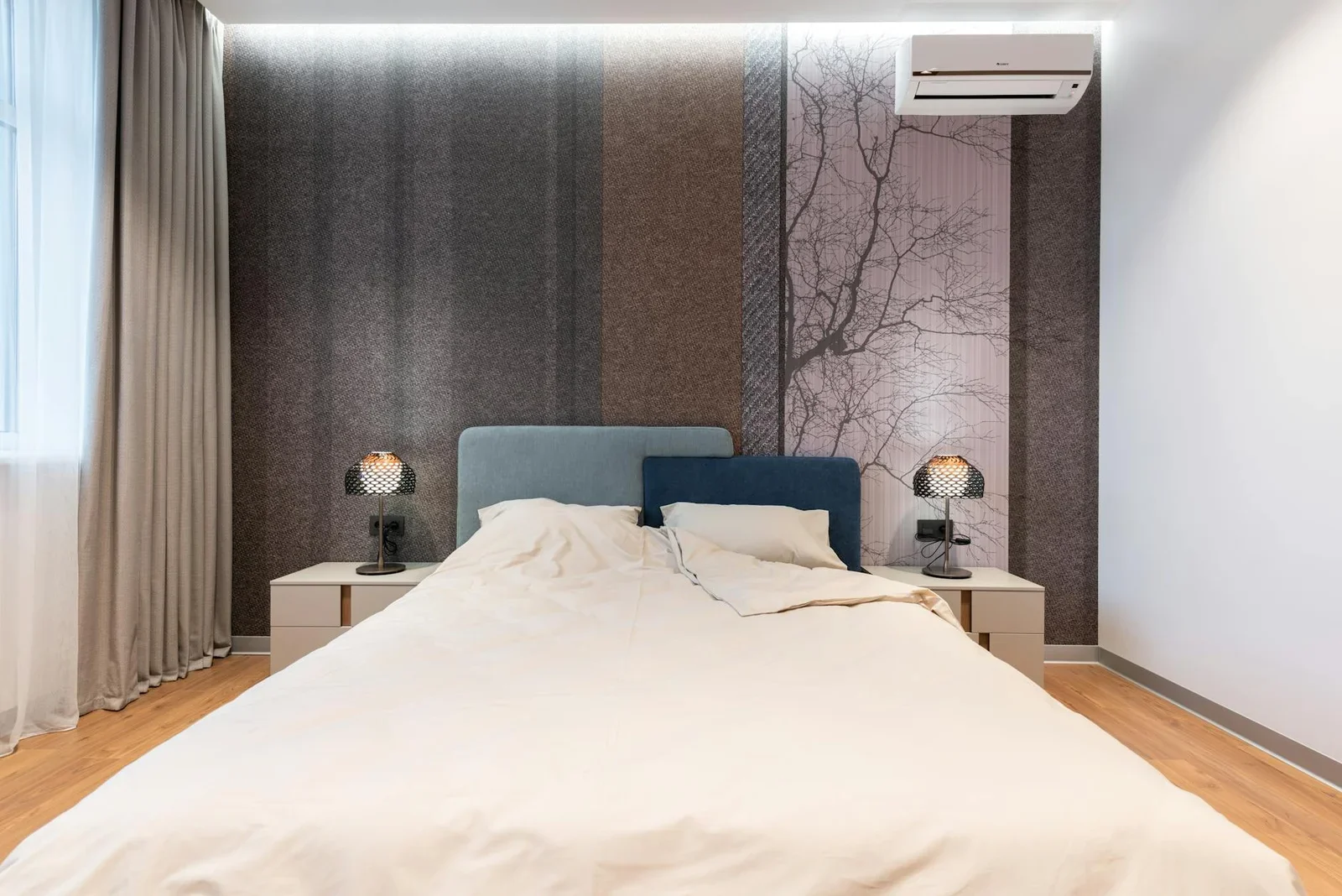 Phòng ngủ tông sáng hiện đại lát sàn gỗ ấm áp, giường kê gần bàn đầu giường cùng đèn ngủ và rèm cửa hài hòa. | Thiết kế nội thất 24