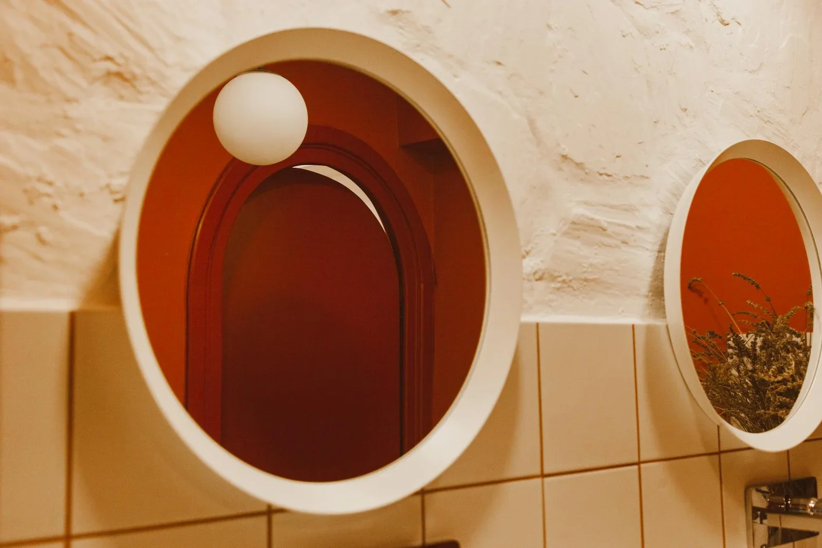 Elegant bathroom interior with round mirrors, warm lighting, | Thiết kế nội thất 24