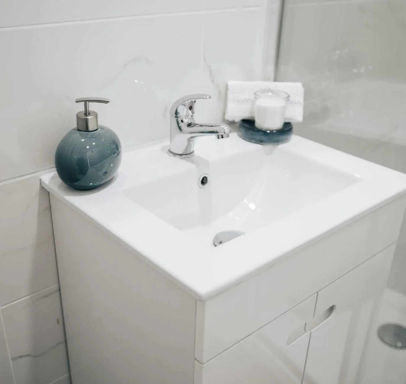 A clean and modern bathroom sink with a chrome faucet, soap  | Thiết kế nội thất 24