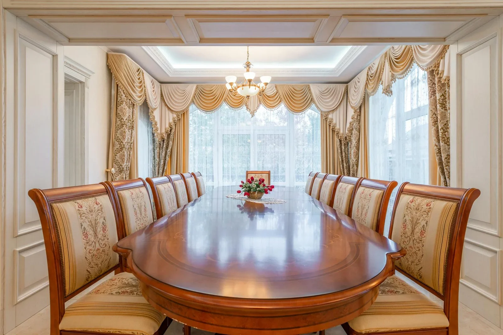 A beautifully decorated dining room featuring a long wooden  | Thiết kế nội thất 24