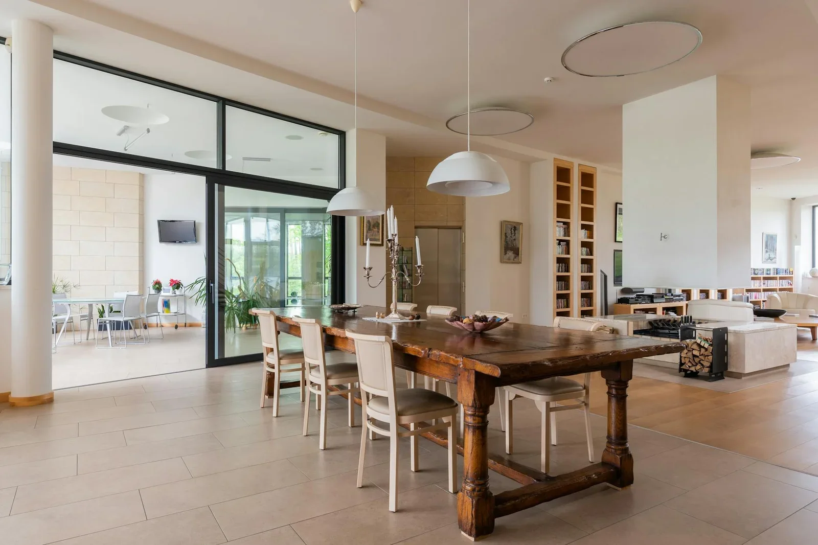 Wooden table with candlestick and chairs placed near modern  | Thiết kế nội thất 24