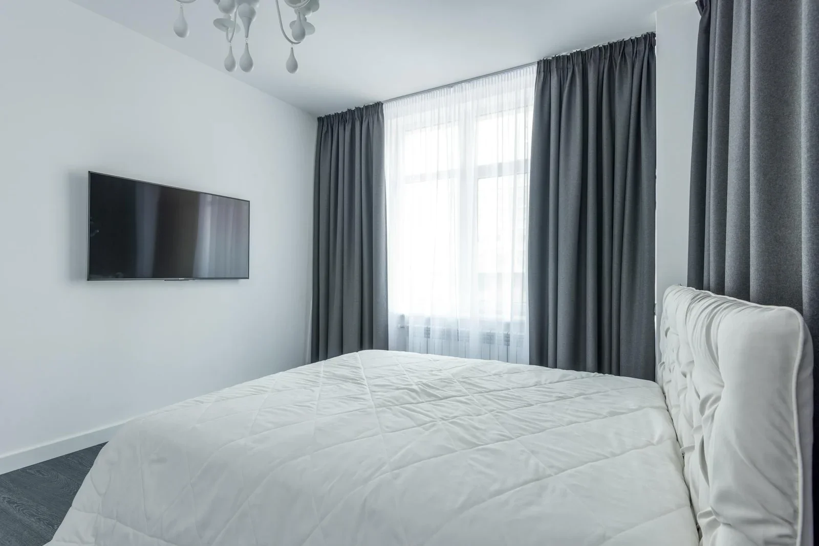 A modern bedroom featuring minimalist decor with a flat-scre | Thiết kế nội thất 24
