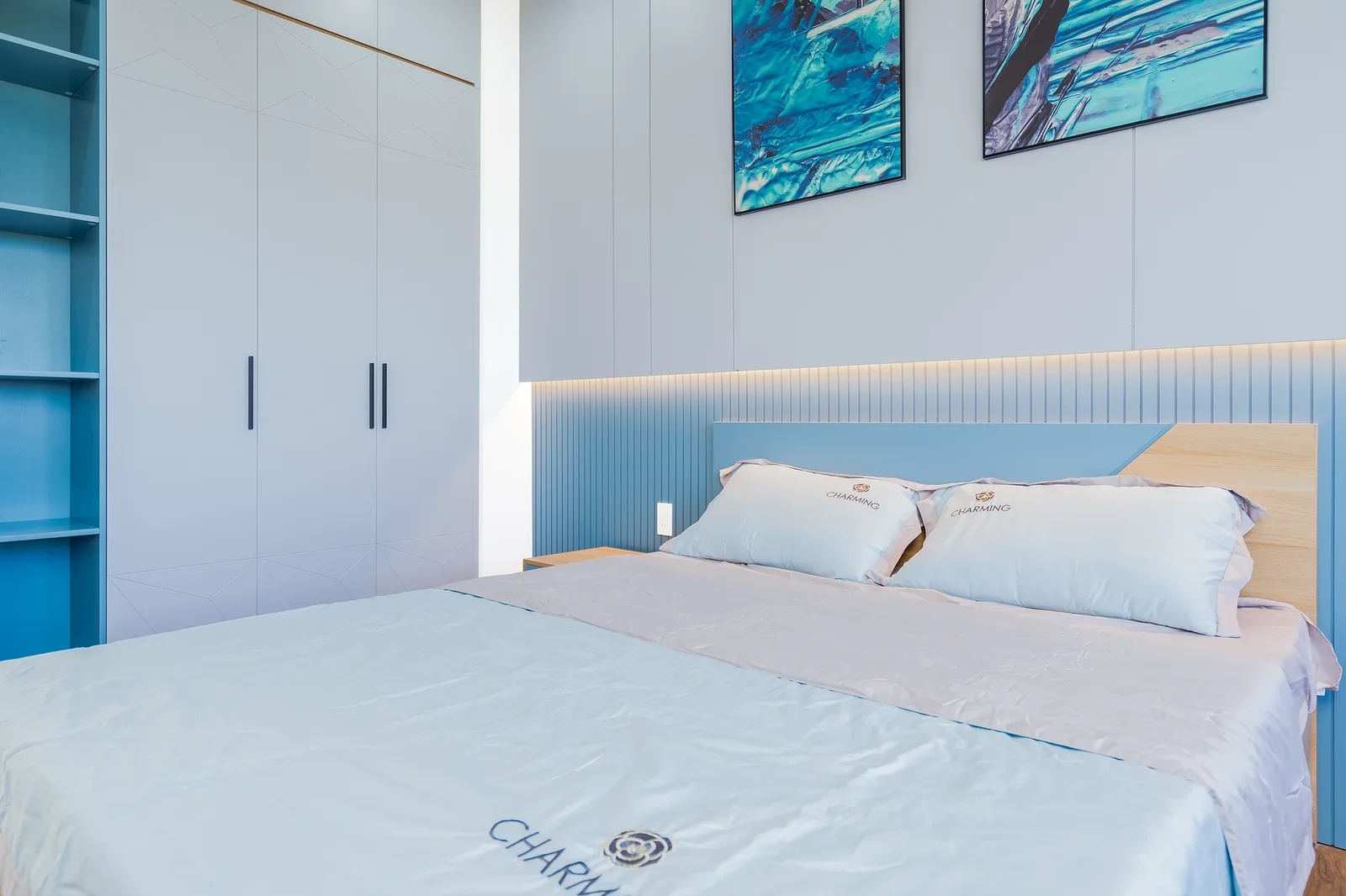 Elegant bedroom with blue accents featuring a cozy bed and m | Thiết kế nội thất 24