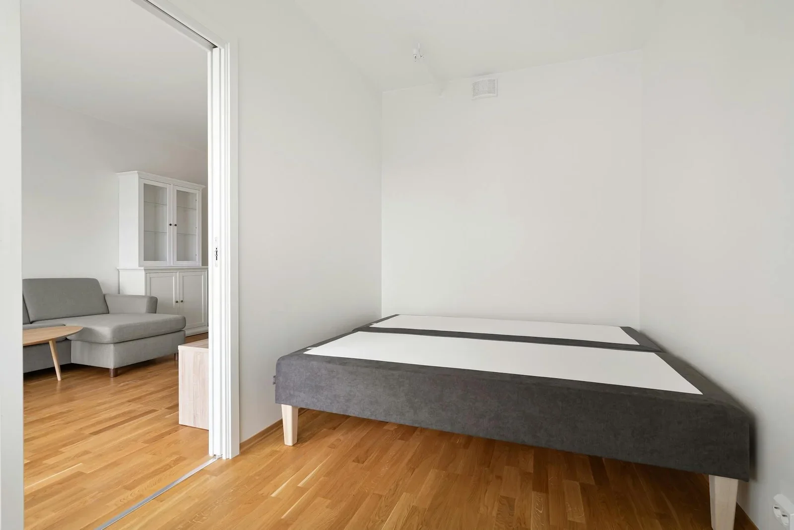 Spacious minimalist bedroom featuring a modern sofa and bed  | Thiết kế nội thất 24