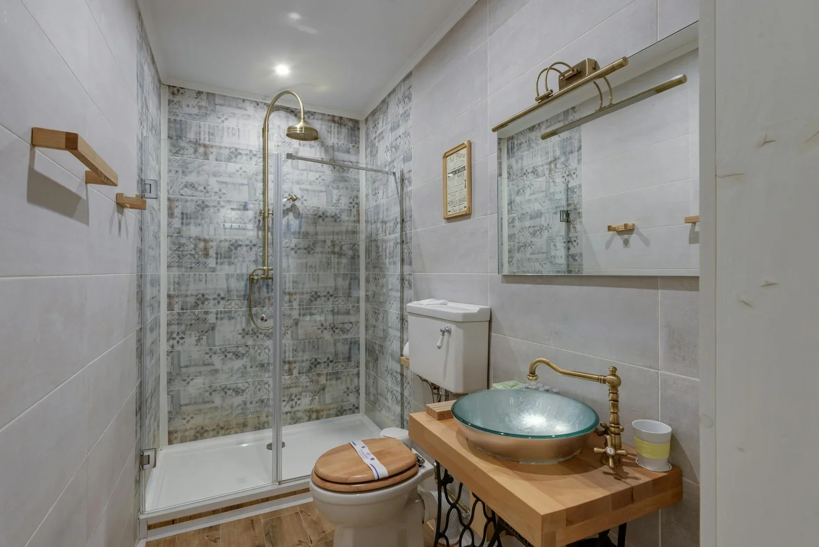 A stylish modern bathroom featuring a glass shower, vessel s | Thiết kế nội thất 24