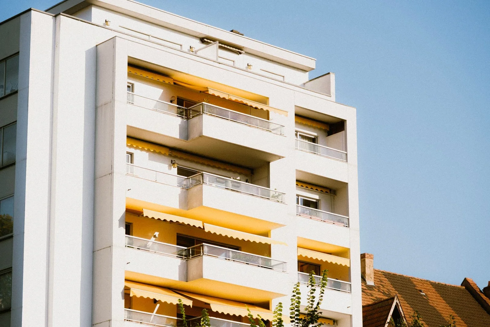 Low-angle view of a contemporary apartment building with yel | Thiết kế nội thất 24
