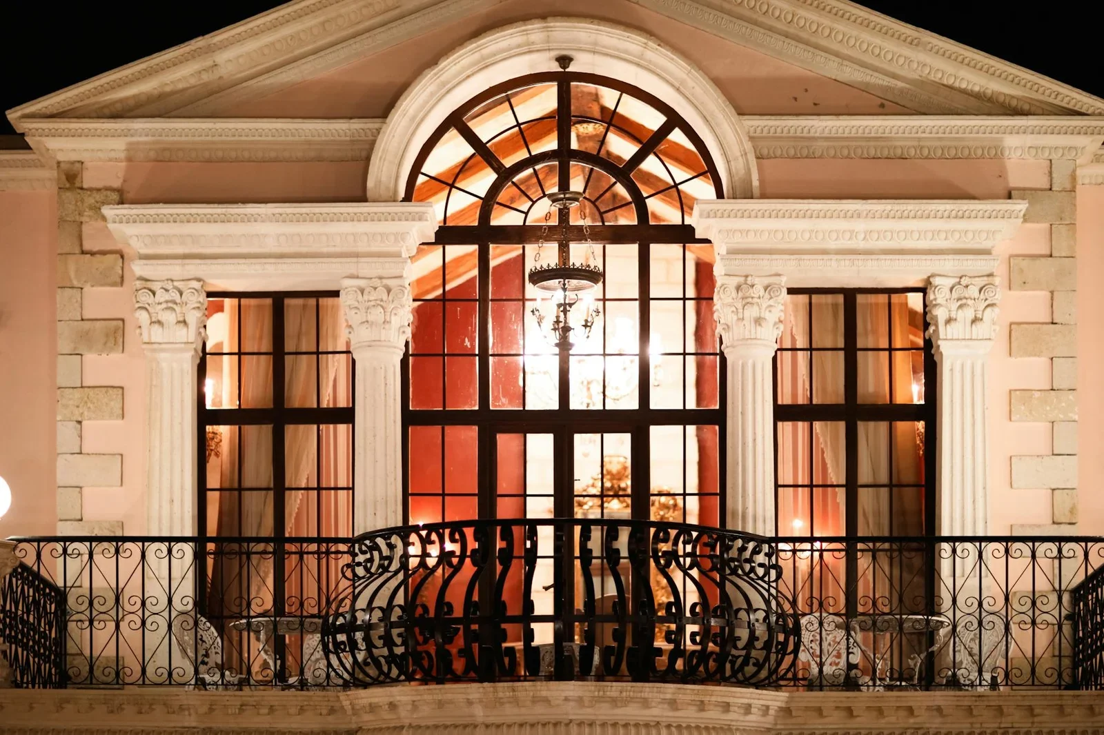 An illuminated neoclassical balcony at night showcasing orna | Thiết kế nội thất 24