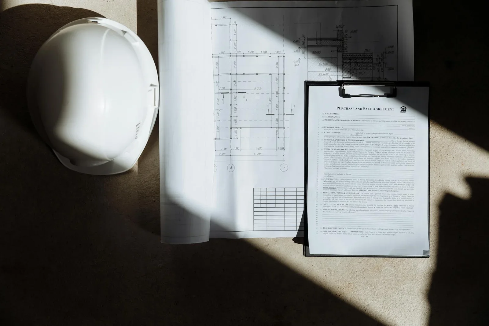 Top view of construction documents and hard hat in sunlight, | Thiết kế nội thất 24