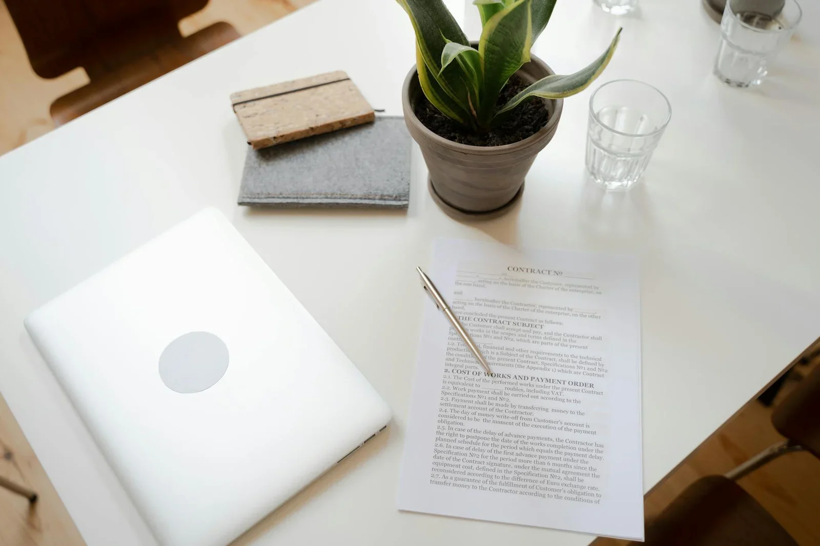 Top view of a clean workspace with laptop, contract, and pla | Thiết kế nội thất 24