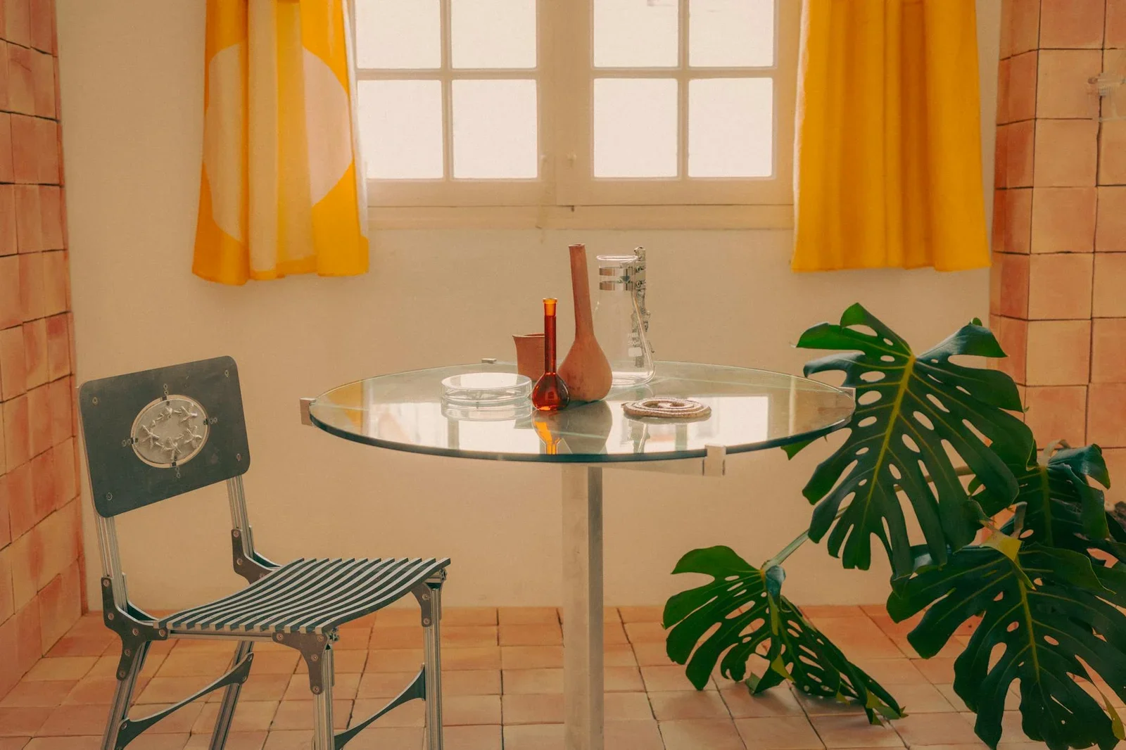 A cozy vintage-style room featuring a glass table, chair, an | Thiết kế nội thất 24