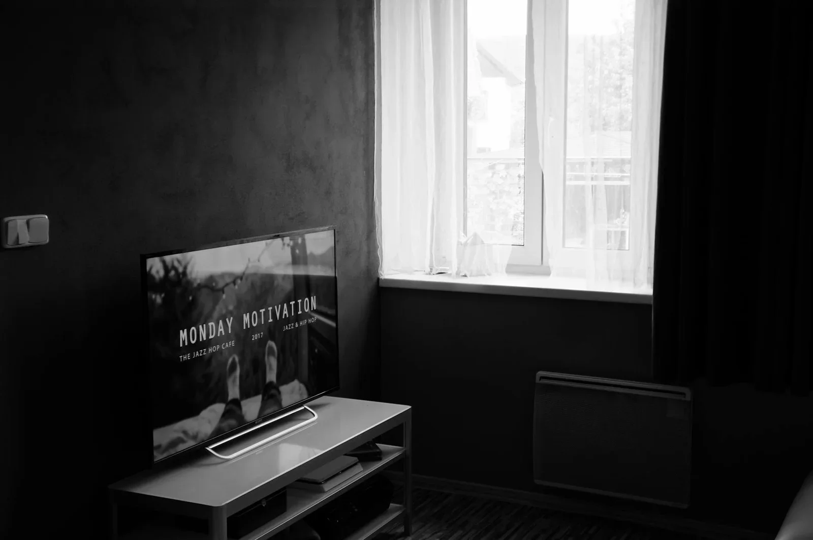 Black and white photo of a modern interior featuring a TV an | Thiết kế nội thất 24