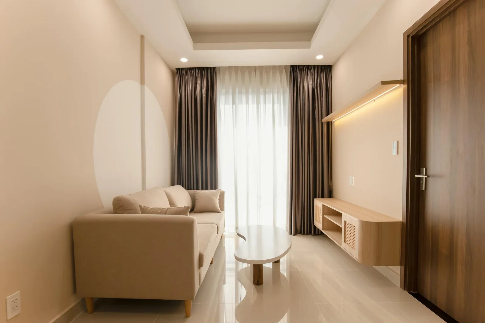 A minimalist living room with a beige sofa, modern table, an | Thiết kế nội thất 24