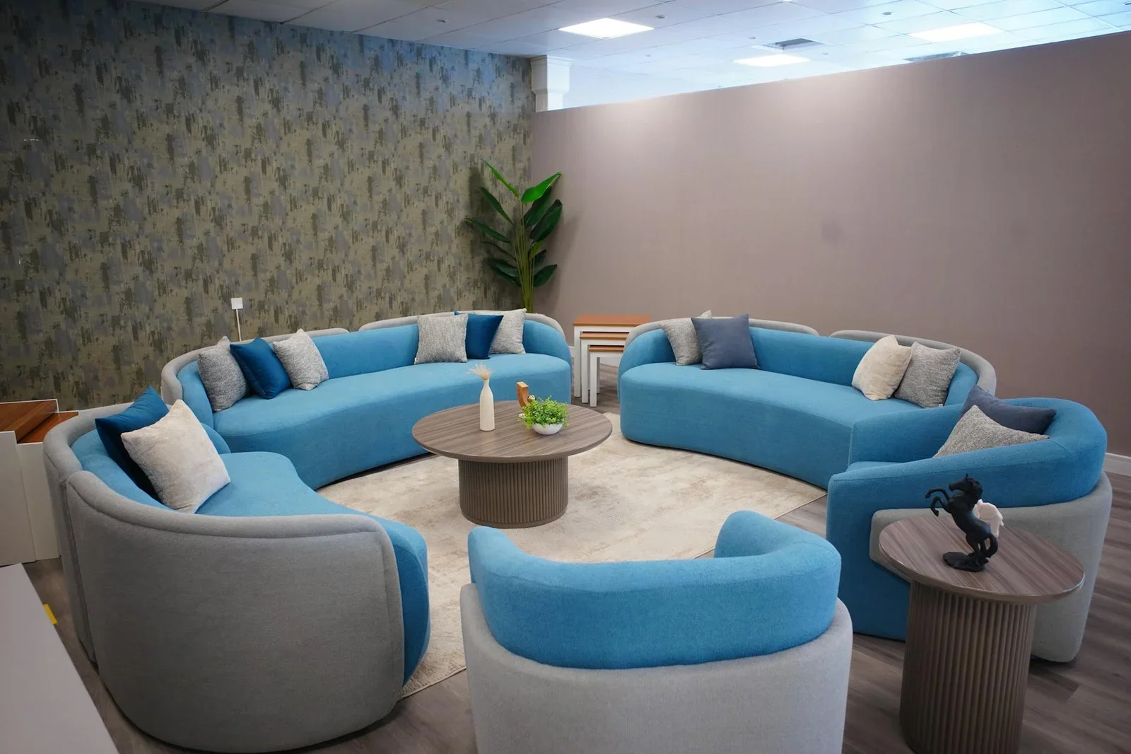 Ghế sofa tròn xanh độc đáo dưới ánh sáng vàng ấm áp, mang đến phòng khách sang trọng, quây quần và thư thái. | Thiết kế nội thất 24