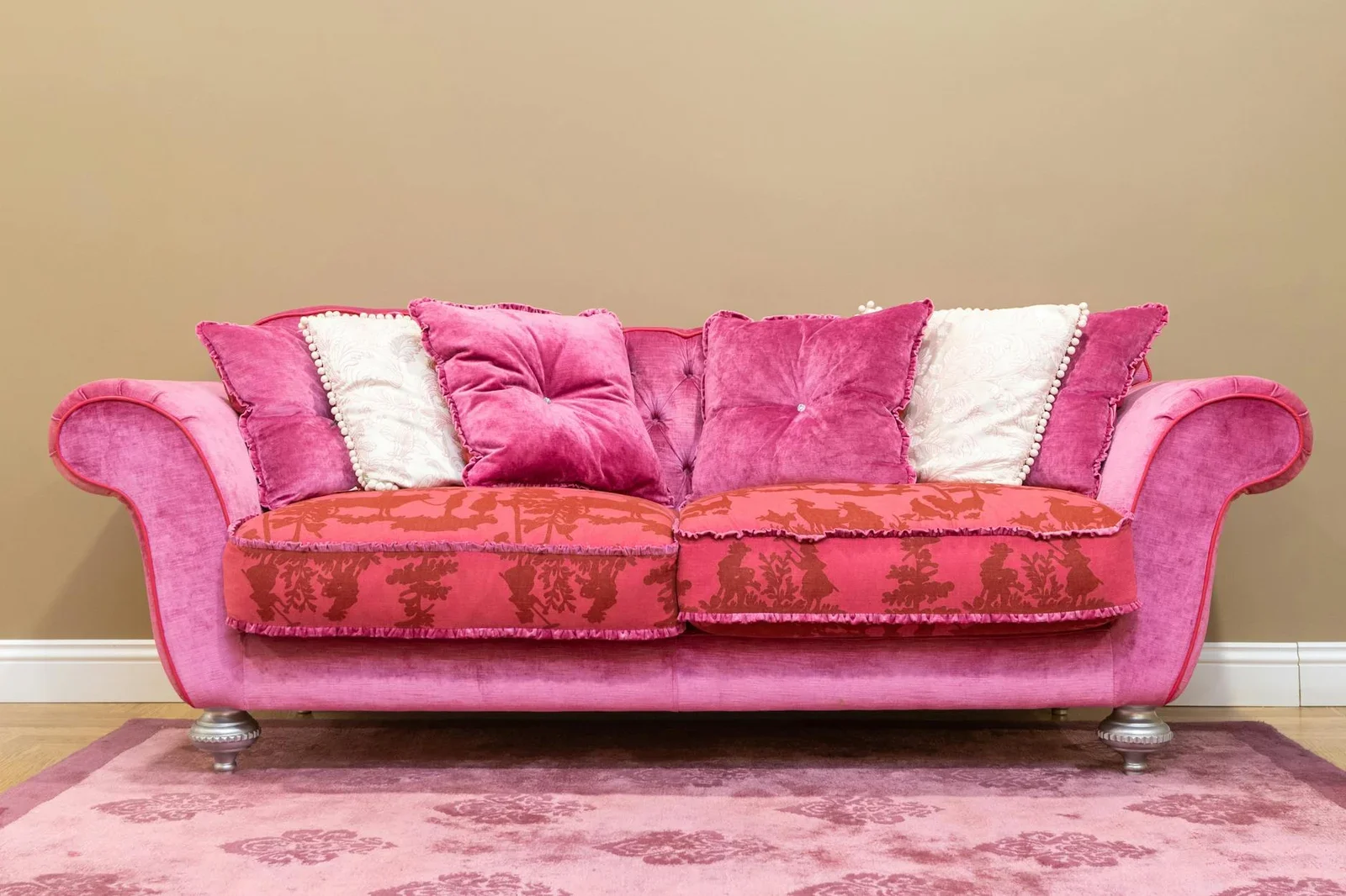 Elegant pink sofa with plush pillows against a brown backgro | Thiết kế nội thất 24