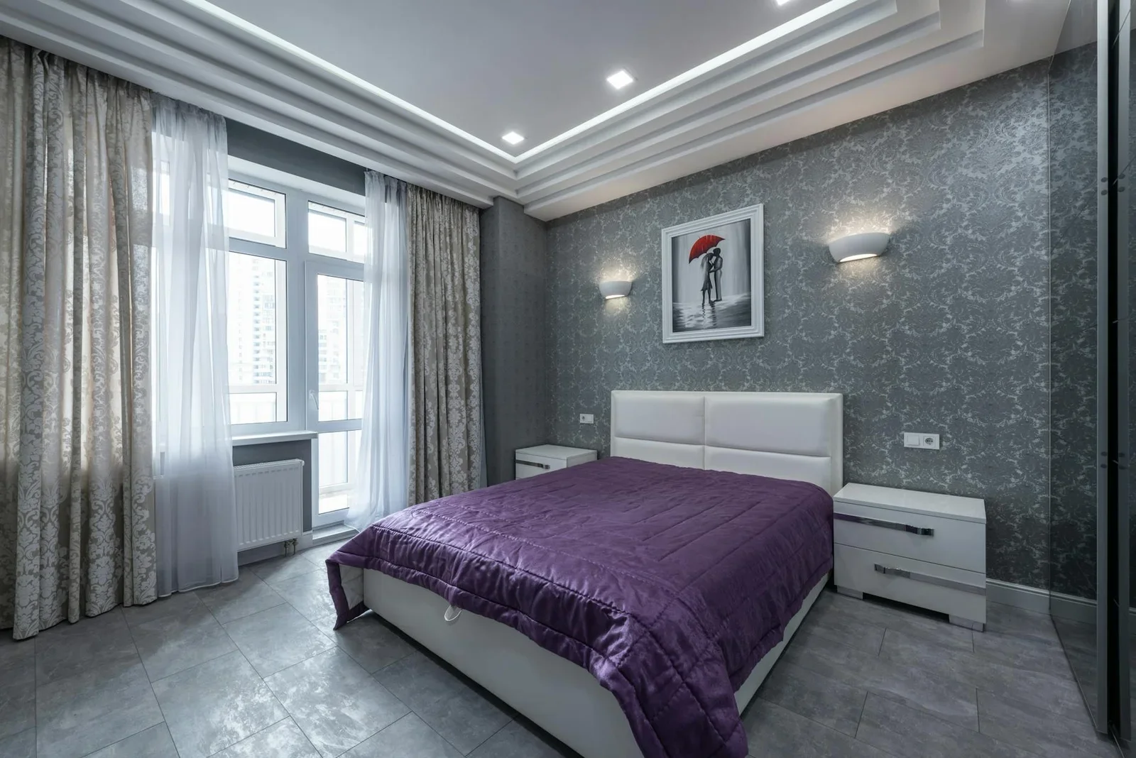 Phòng ngủ biệt thự hiện đại kết hợp giường trắng, chăn tím nổi bật trên tường xám trung tính, mang lại vẻ đẹp tinh tế. | Thiết kế nội thất 24