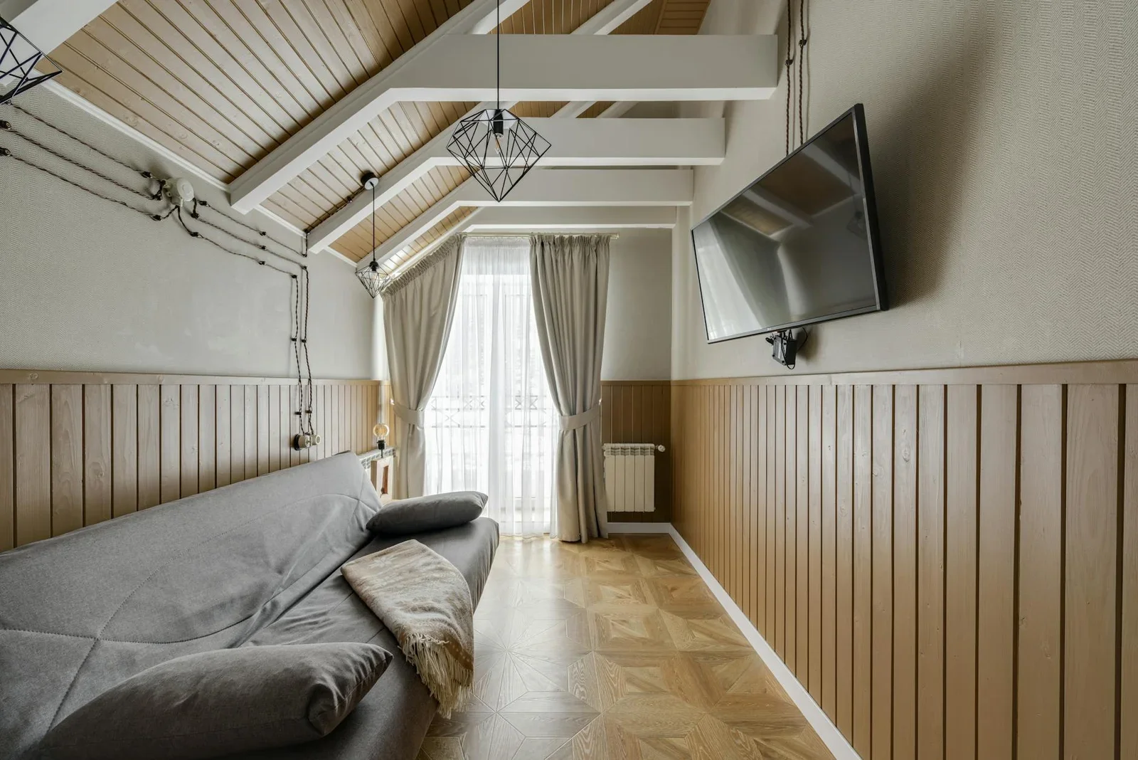 Stylish living room with a couch, TV, and natural light from | Thiết kế nội thất 24