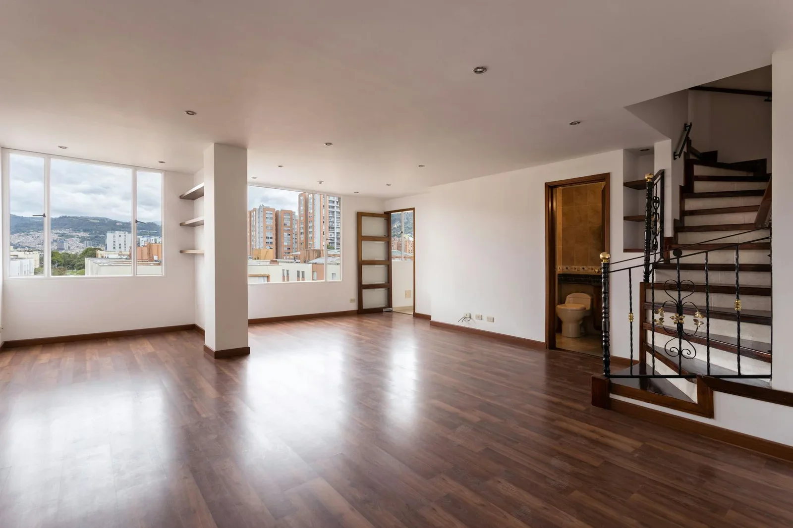 Bright empty living room with wooden floors, large windows, | Thiết kế nội thất 24