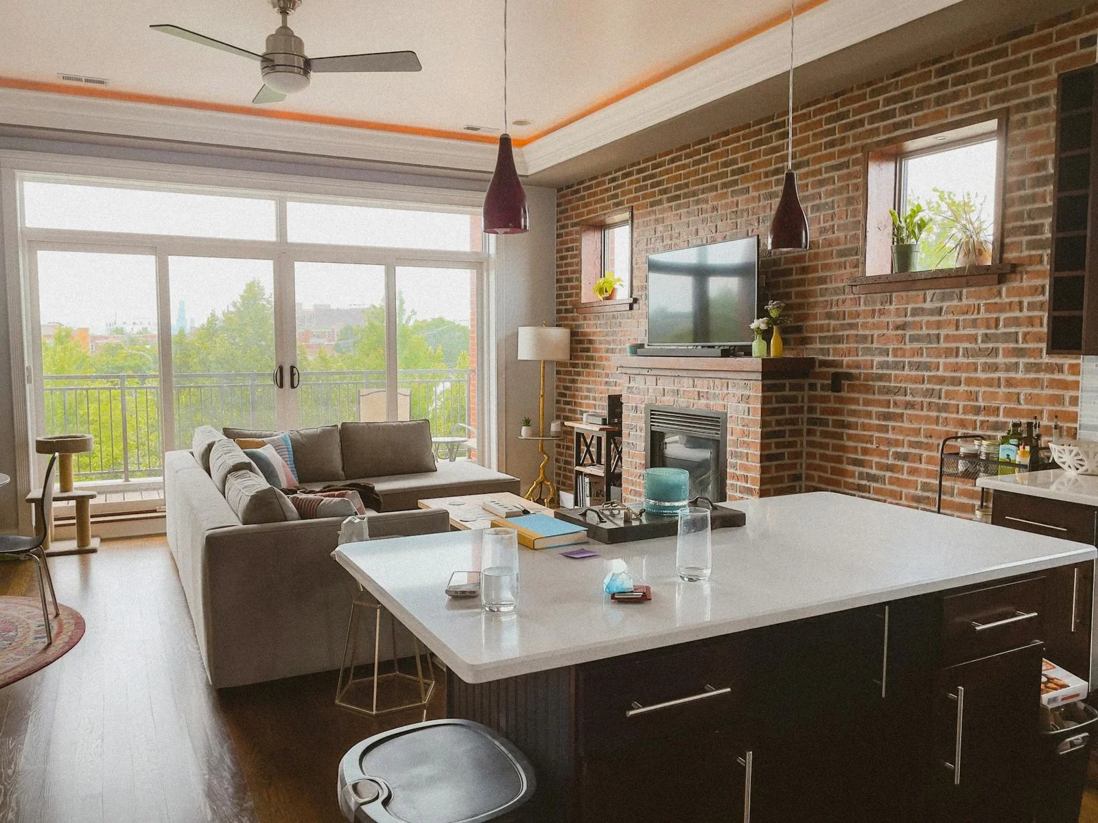Spacious living room featuring a brick wall, fireplace, and | Thiết kế nội thất 24