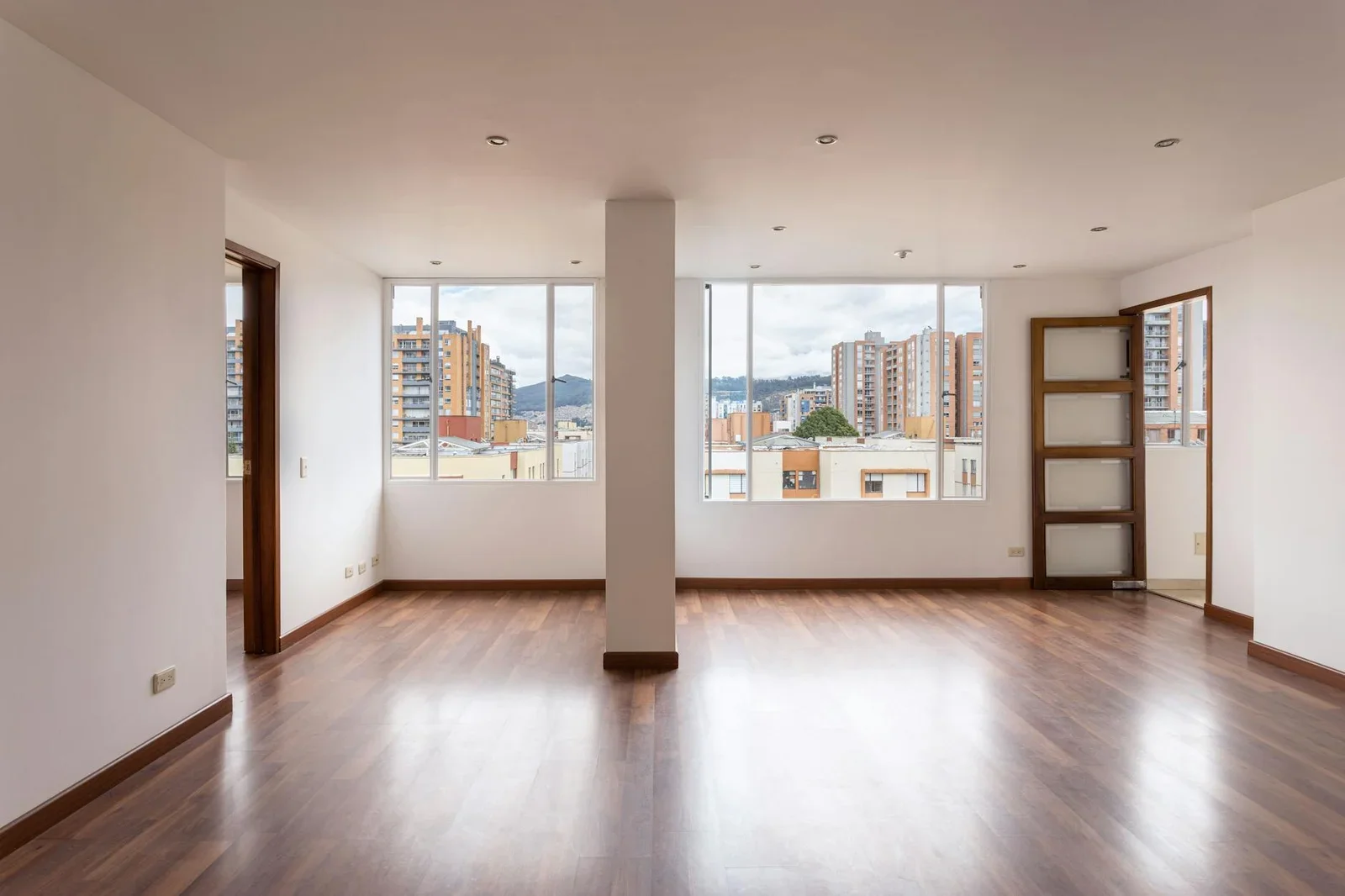 An empty, bright apartment interior showcasing wide windows | Thiết kế nội thất 24
