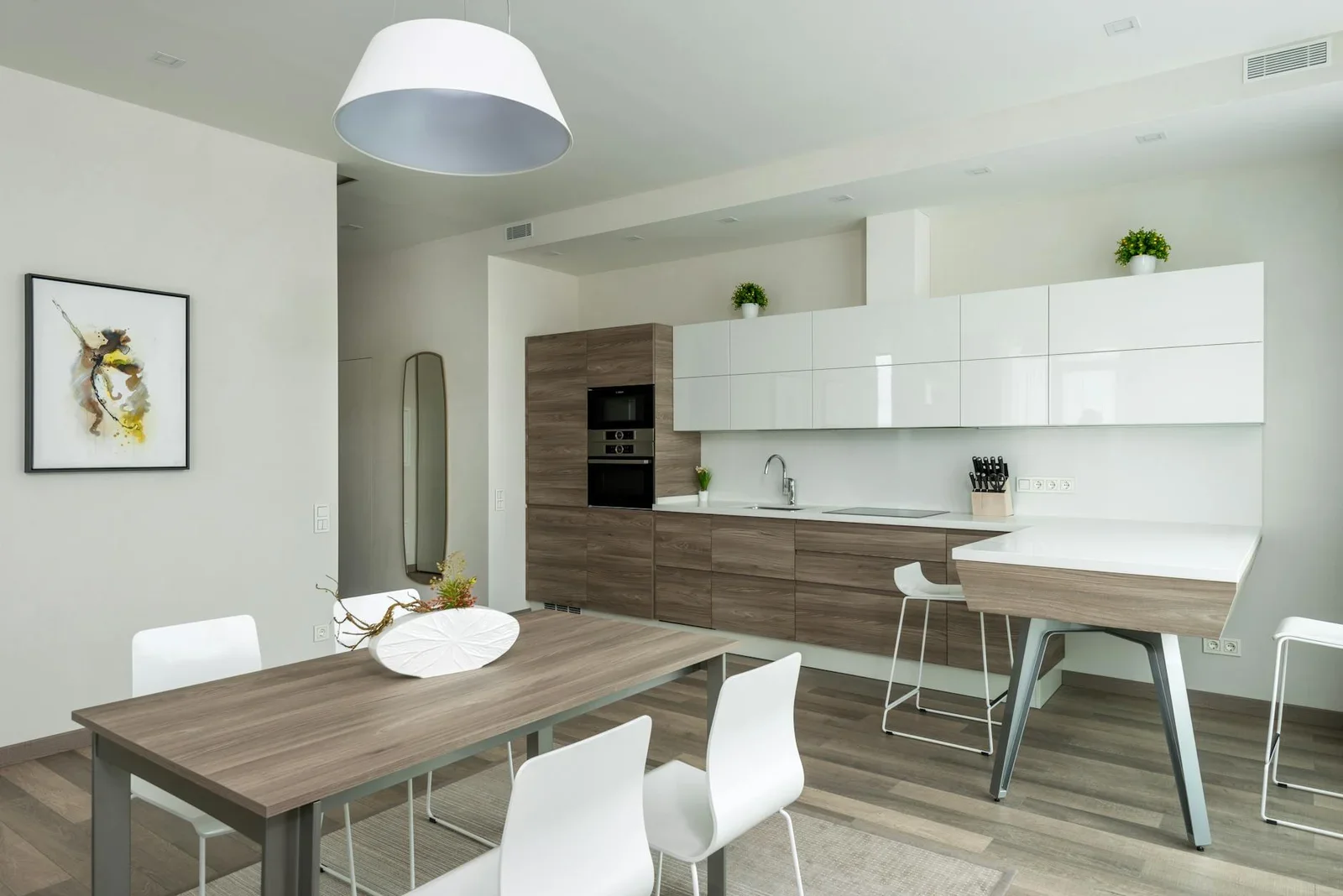 Wooden table with chairs placed near counter and cabinets in | Thiết kế nội thất 24