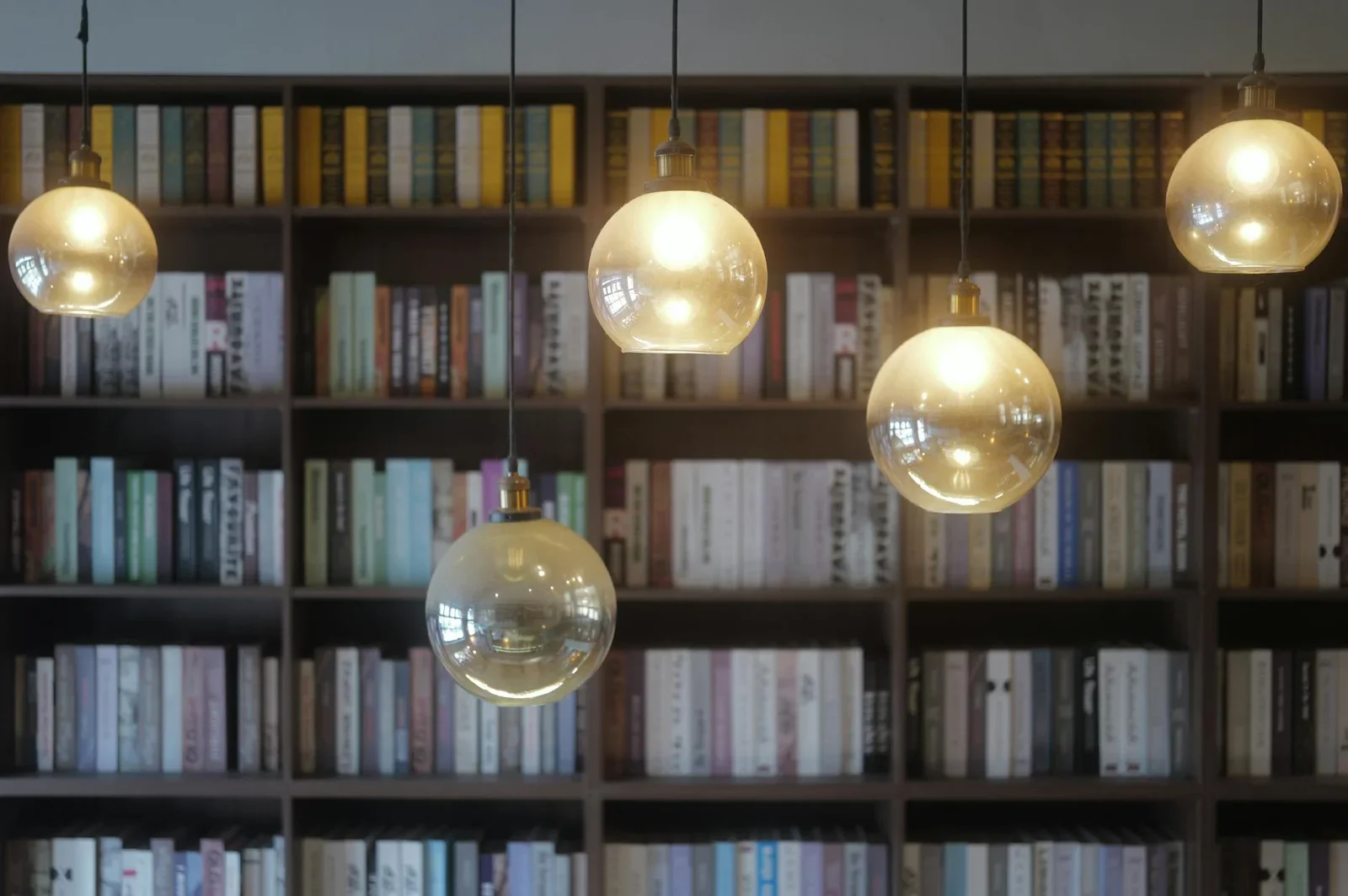 Warm ambient lighting in a home library with bookshelves. | Thiết kế nội thất 24