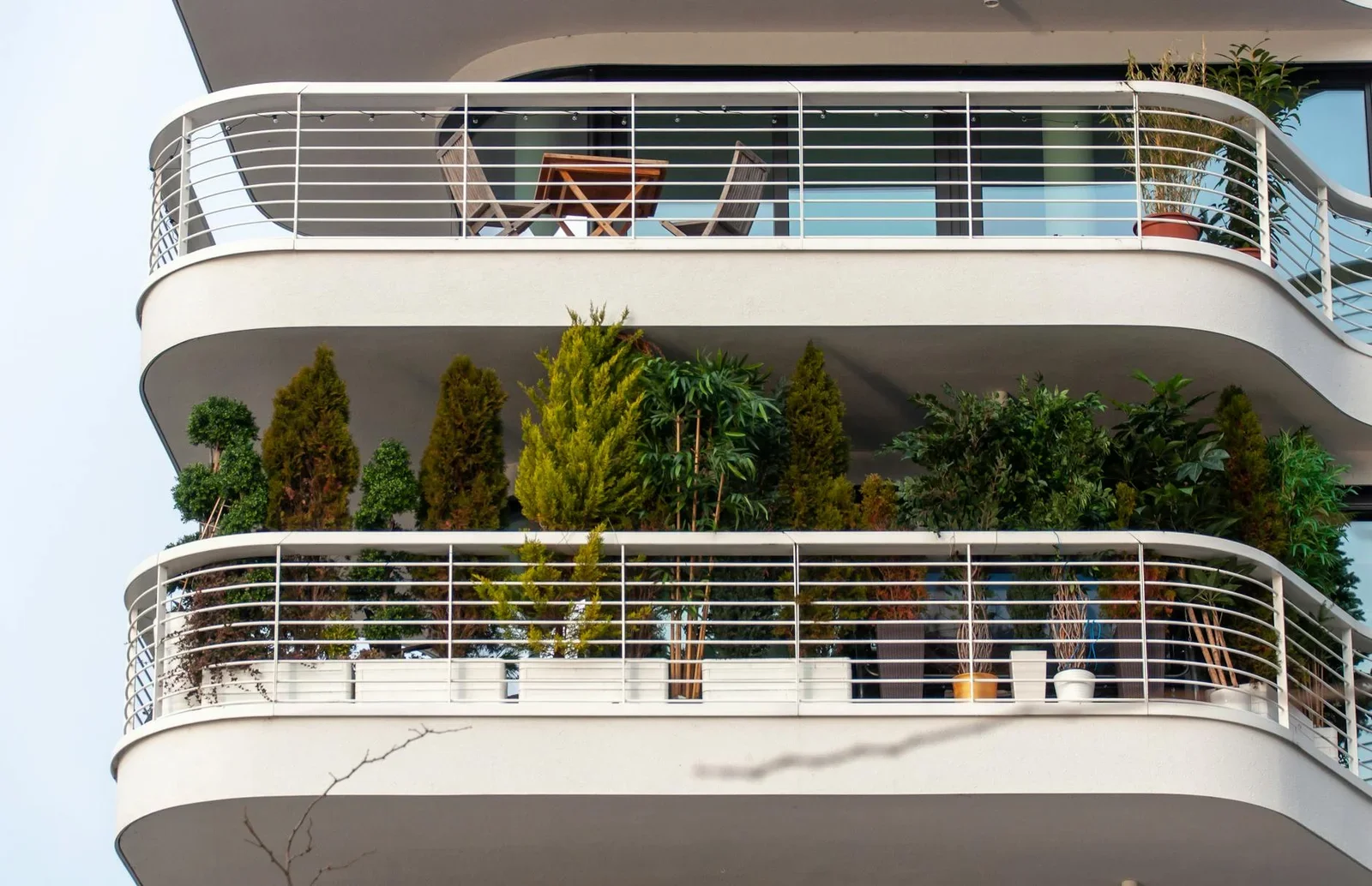 Sophisticated apartment balcony adorned with lush plants and | Thiết kế nội thất 24